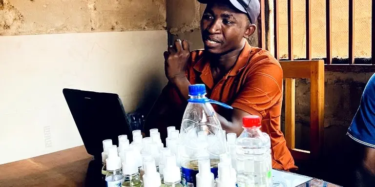 AfyaGuard founder leading a repellent production training session